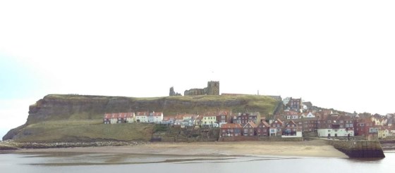 Whitby Abbey on the cliff top, overlooking the old town and the bay.
