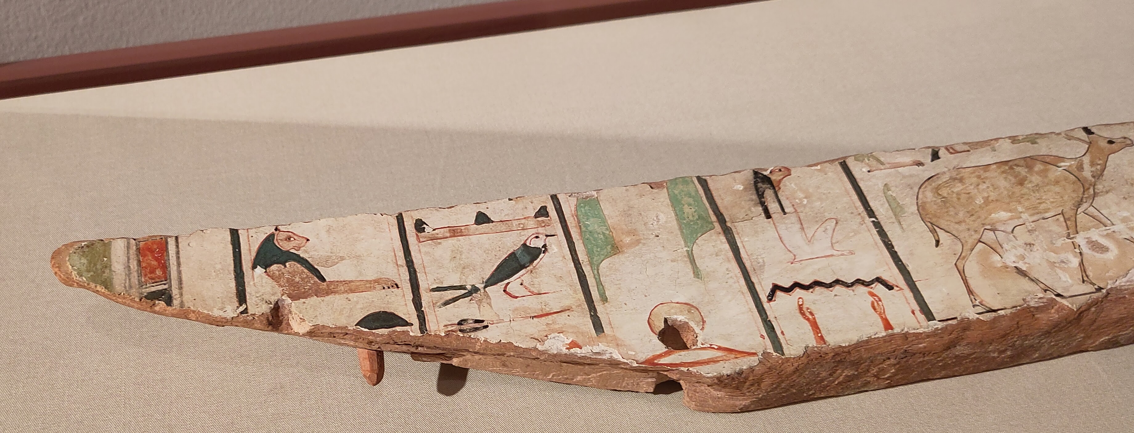 Fragment of painted coffin wood, featuring birds and animals.